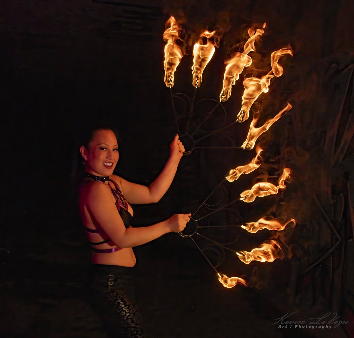 Lavender Mei performing with lit fire fans after dark